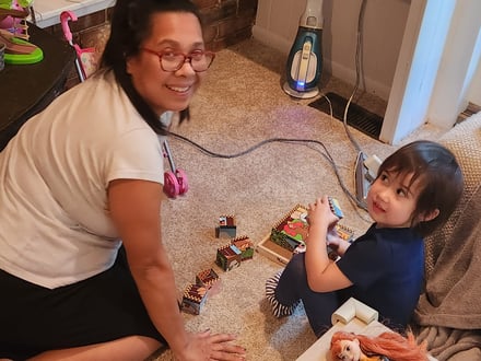 Rowena playing a puzzle on the floor with Kerrigan