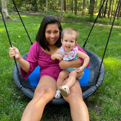 Dr. Rowena Winkler with her daughter, Kerrigan, on a swing